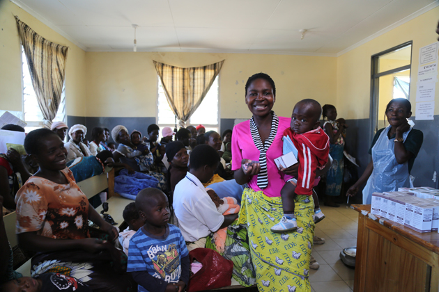 Love Saidi is collecting antiretrovirals for her husband and herself. By starting HIV treatment early, Love was able to ensure her baby, Patience, was born HIV-free.