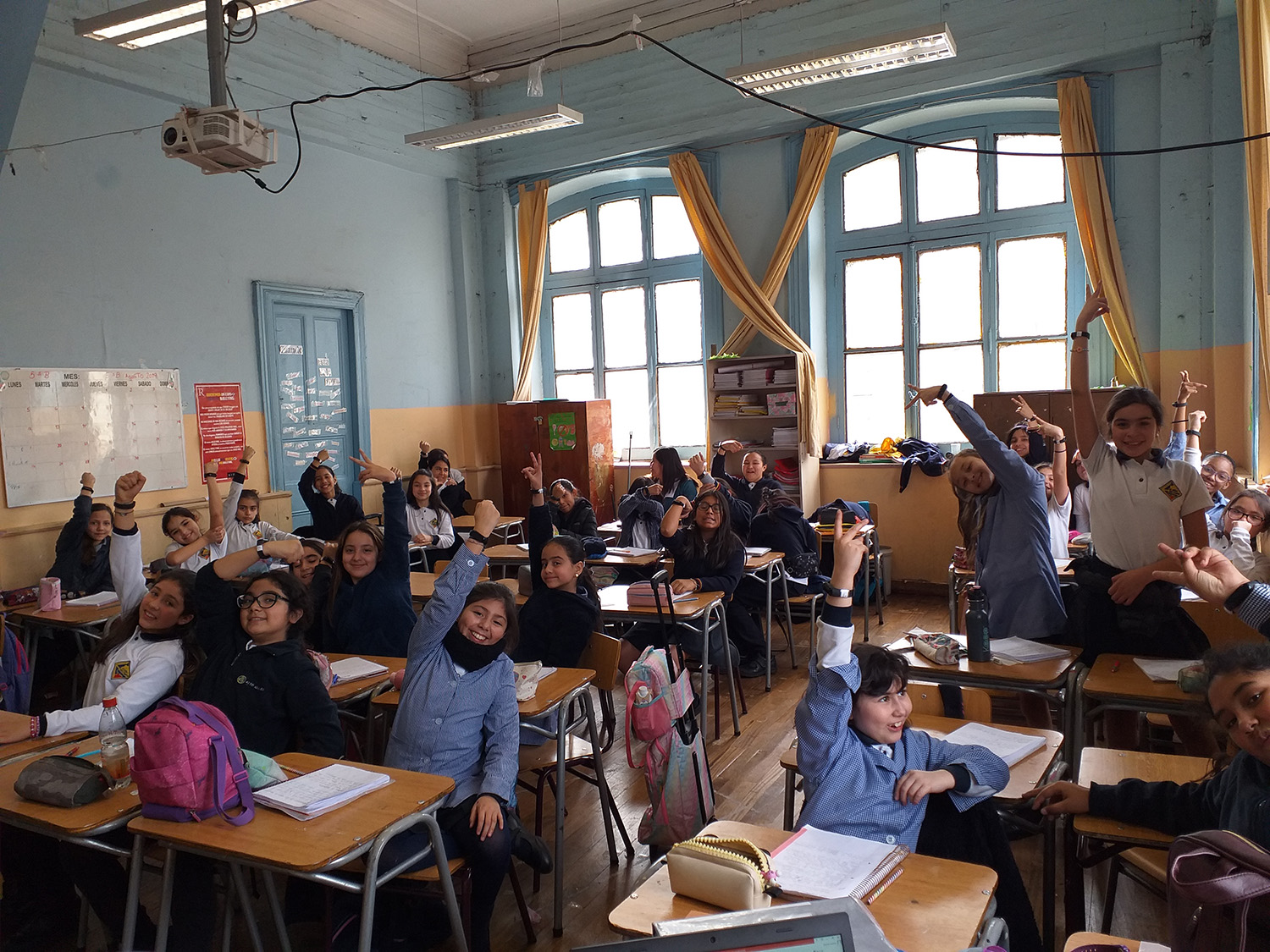 classrooms of children holding up pedometers