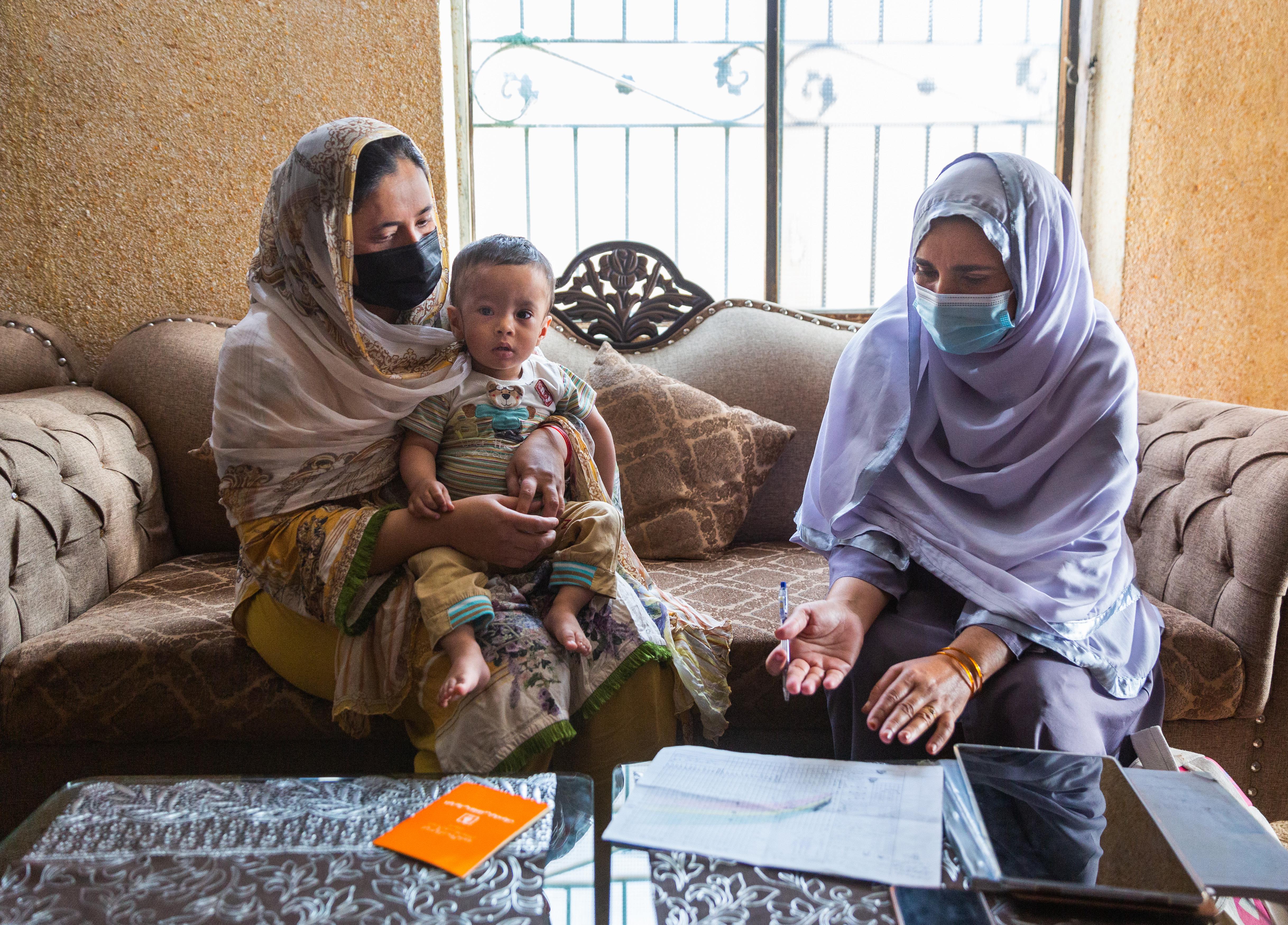 A health worker visits a woman and her 14-month-old son in Pakistan to provide postnatal care, and information on  contraception and abortion.
