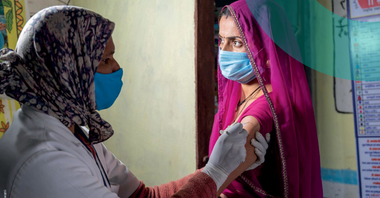 Woman receiving a vaccine, India