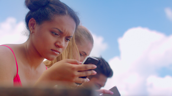 A girl is looking at her mobile phone