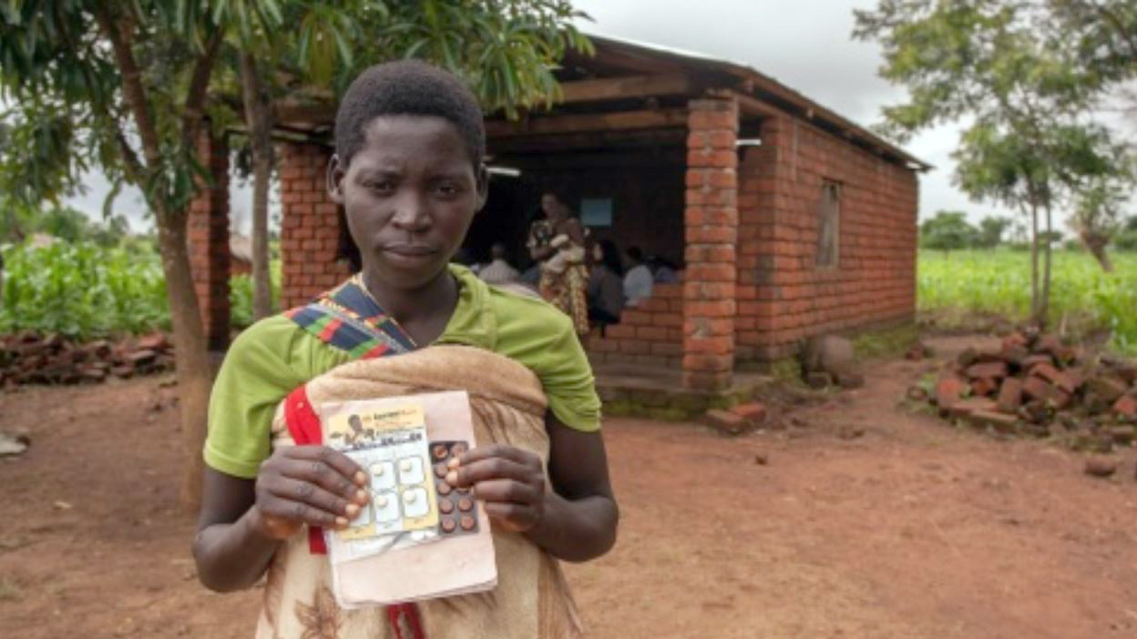 the mother of a baby girl holds the medicines her child needs