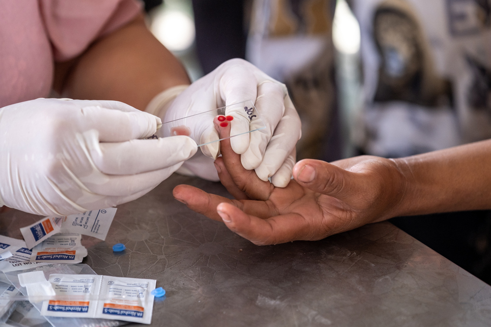 A health worker prepares blood samples for a malaria raoid diagnostic test