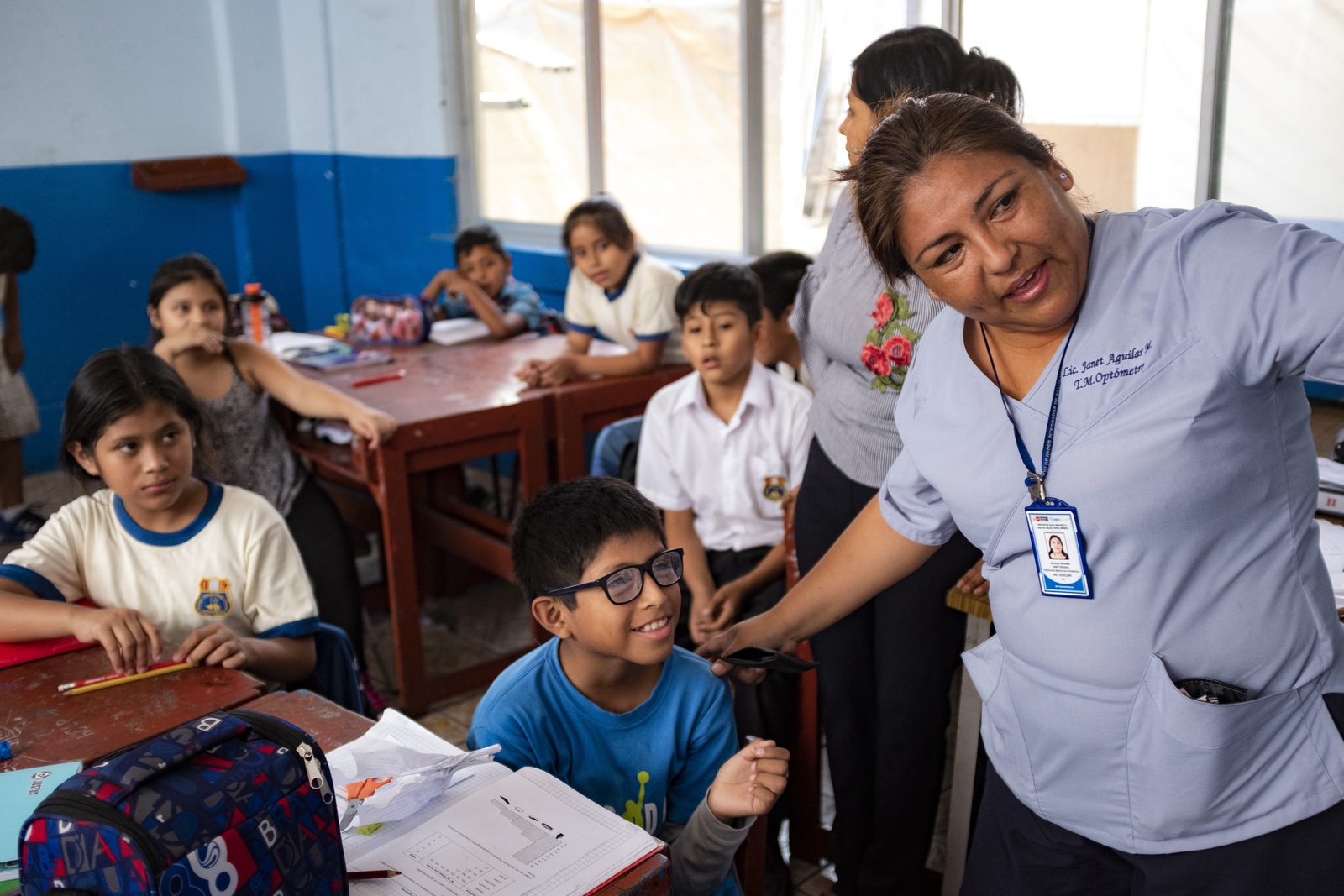 peru child trying on new glasses