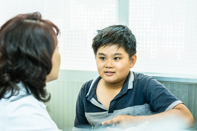 A fourteen year old boy with obesity issues consults with a doctor on healthy eating choices at the Nutrition Center in Ho Chi Minh City, Vietnam.