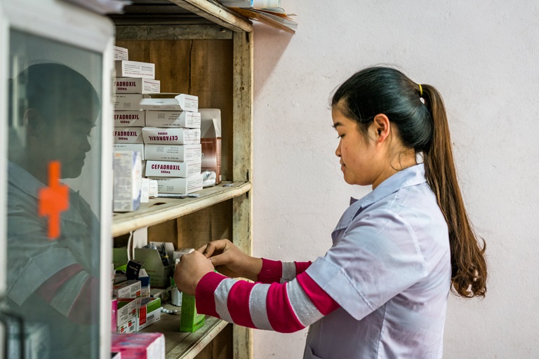A nurse checks the medicine in a small pharmacy at a rural commune health center in Doi Son, Ha Nam Province, Vietnam.