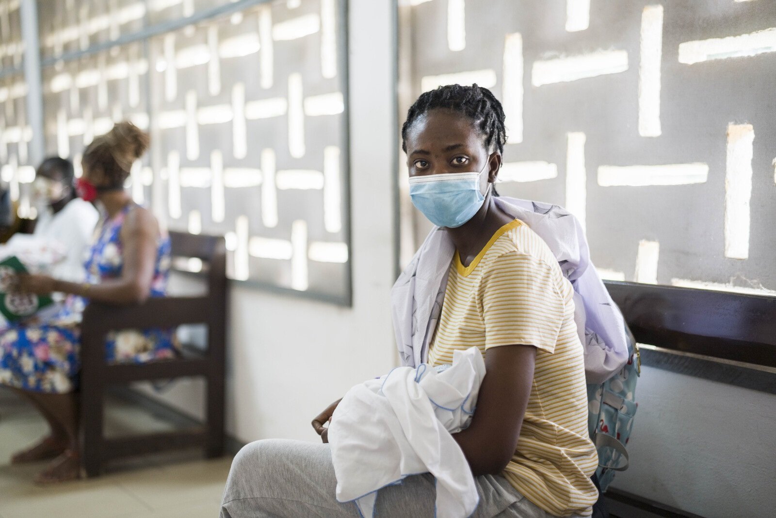 woman in Ghana Woman holding baby in waiting room