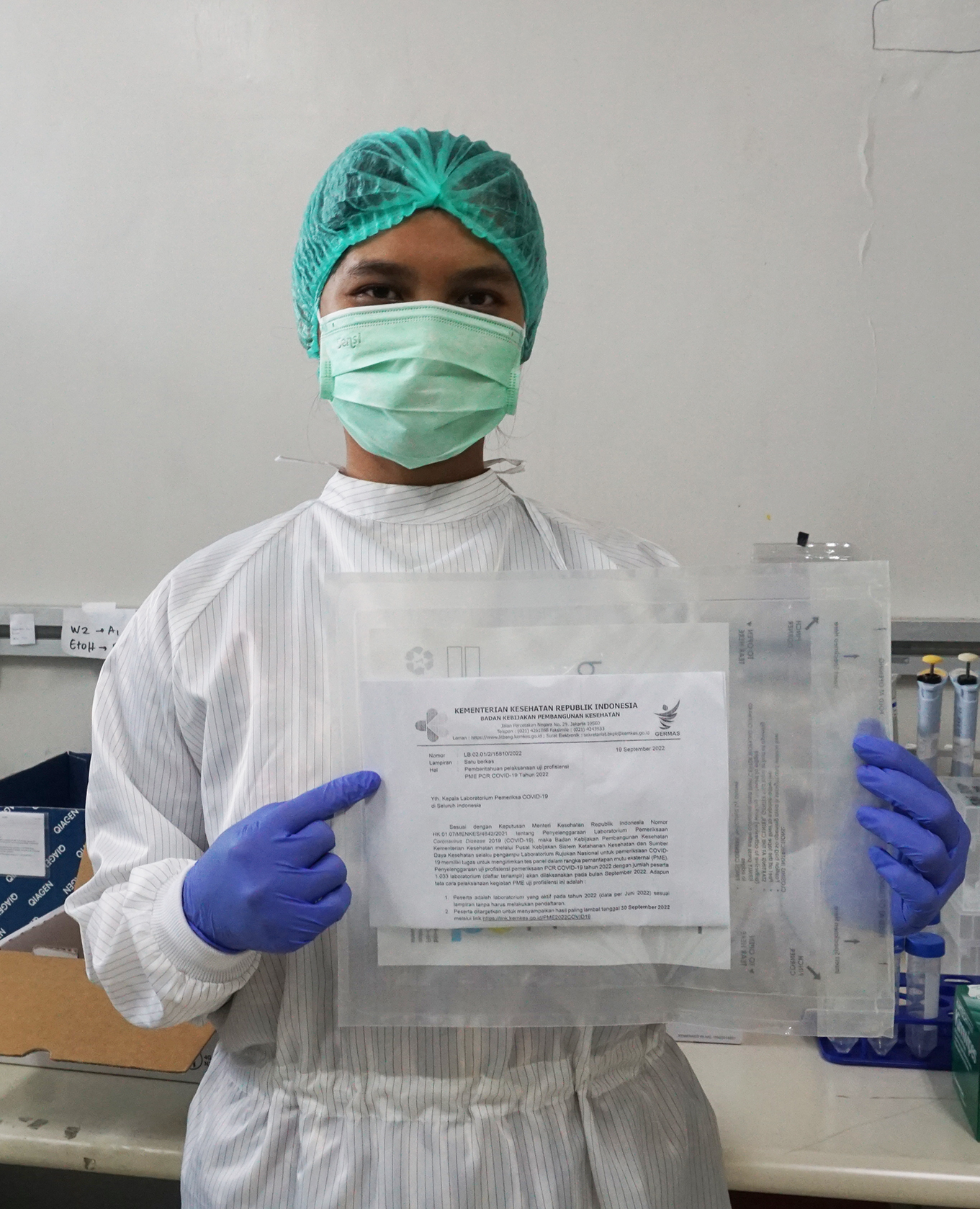 Staff of Prof. Sri Oemijati National Infectious Disease Laboratory with a pouch containing COVID-19 sample panels
