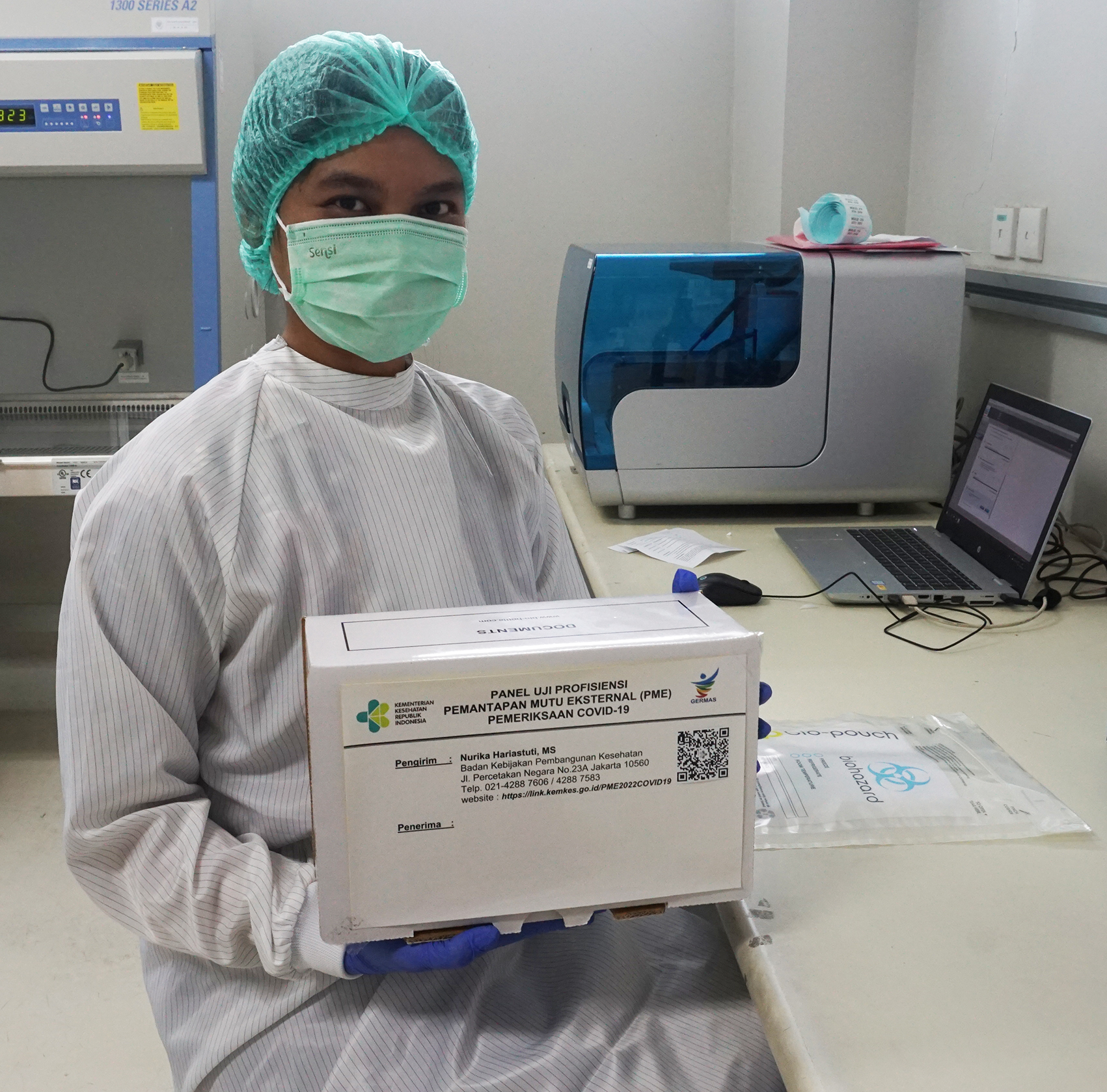 Staff of Prof. Sri Oemijati National Infectious Disease Laboratory with a box containing COVID-19 sample panels,