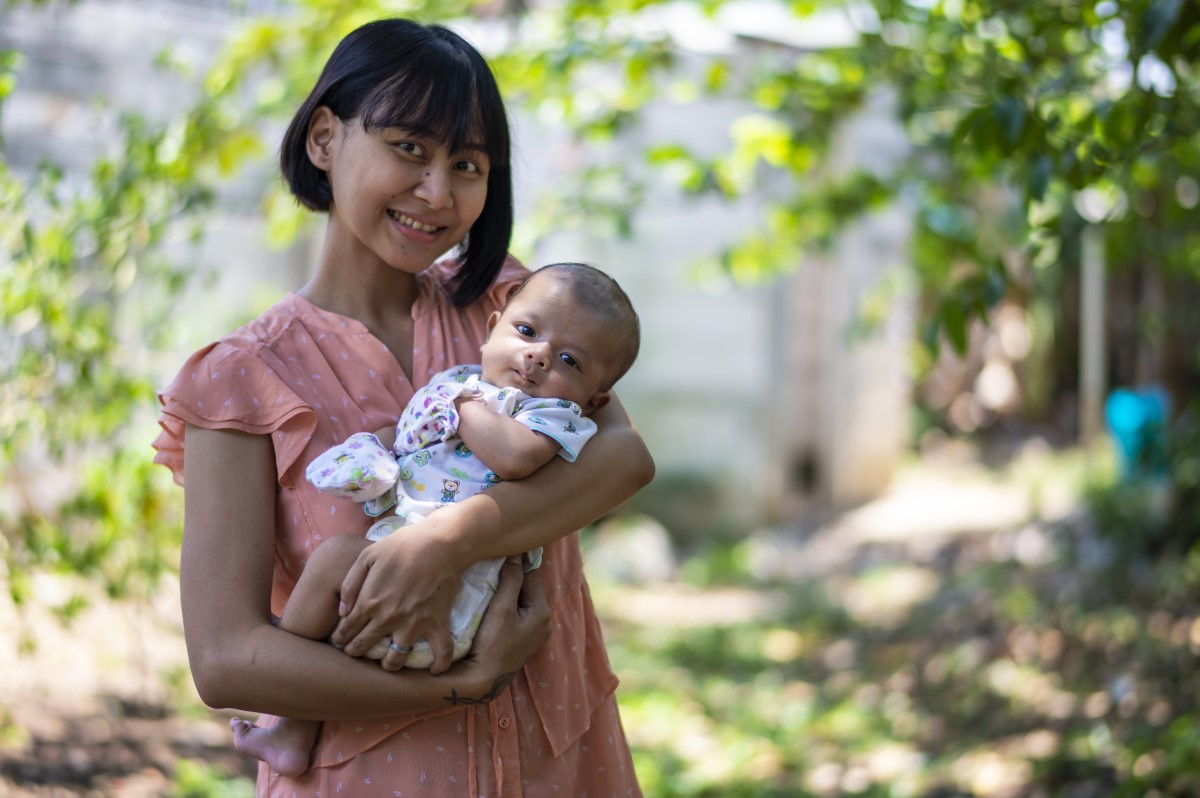 A woman holding a baby.