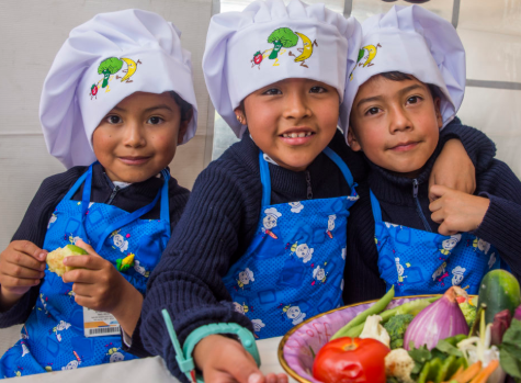 three children dressed as chefs