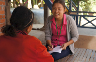 WHO Officer Dany Eng interviews a resident in Roka
